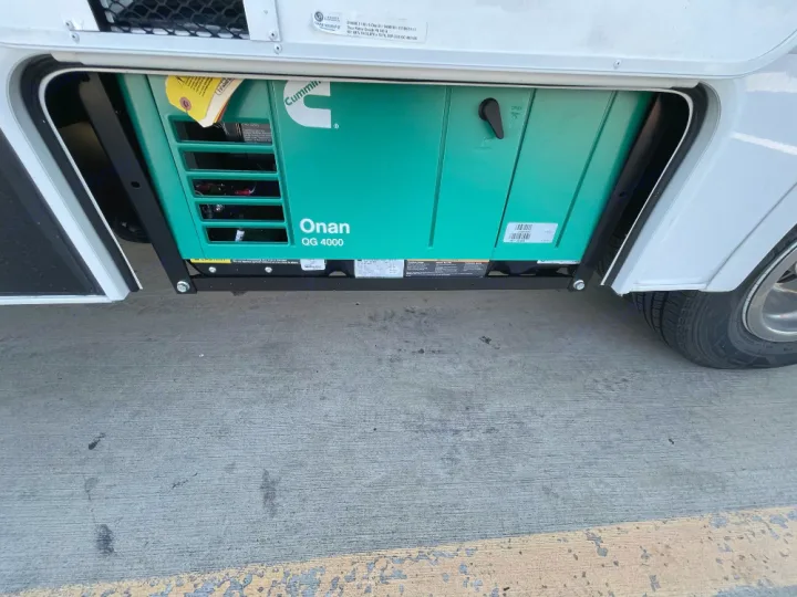 This RV rental includes a built-in green Cummins Onan QG 4000 generator in its open side compartment.. Thor Freedom Elite 2022