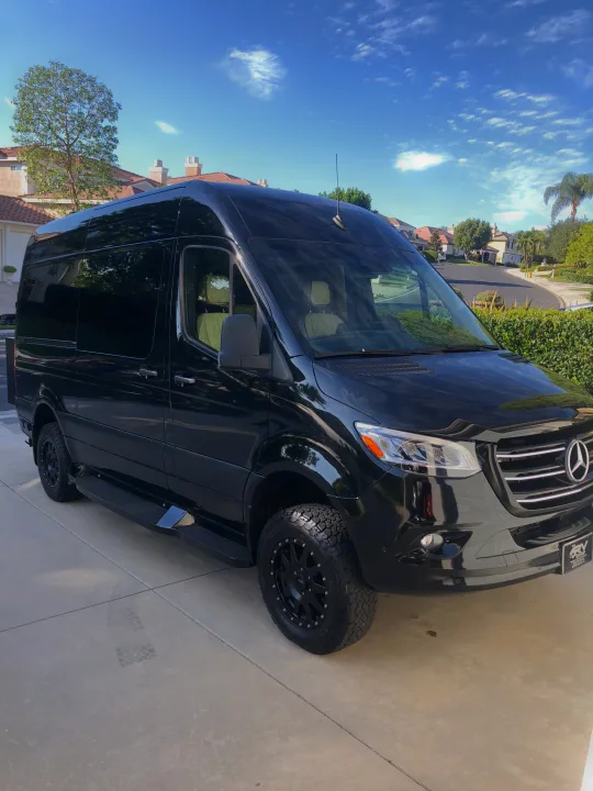 Sleek black Mercedes Sprinter van, equipped for adventure with off-road tires, perfect for your next RV rental.. carson 14 foot 2020