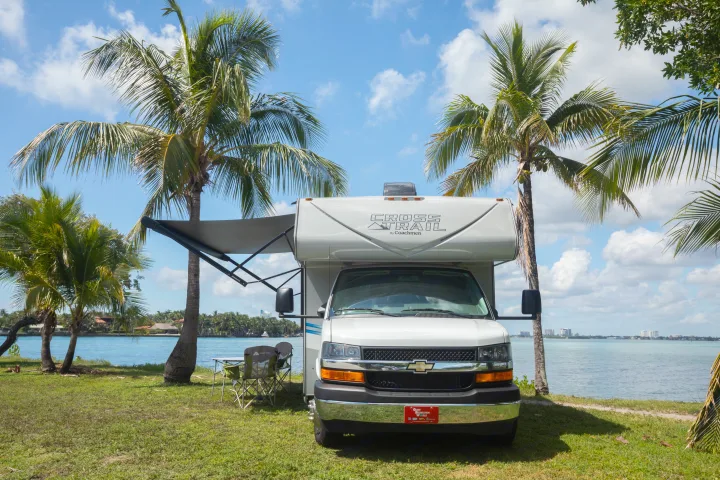 Enjoy your next adventure! This inviting RV rental sits by a sunny bay, surrounded by vibrant palm trees and green grass.. Forest River Coachmen Cross Trail XL 2022