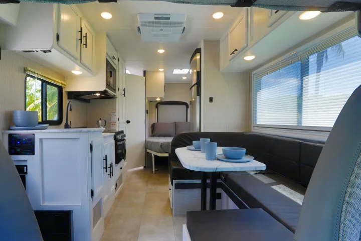 Well-appointed rv rental interior with kitchen, dining, and sleeping areas for comfortable travel.. Forest River Coachmen Cross Trail XL 2022