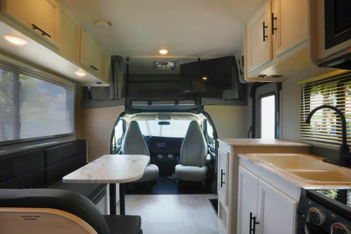 Experience comfort in this RV rental! Features a full kitchen, dining booth, TV, and cab-over bunk.. Forest River Coachmen Cross Trail XL 2022