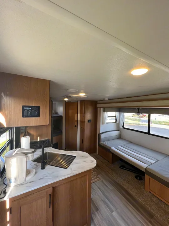 Spacious RV rental interior with modern kitchen, comfy dinette, and bunk beds. Perfect for your next adventure.. Prime Time Avenger 2022
