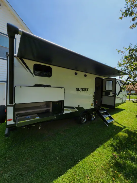 Mid entry door with outside kitchen and awning. Crossroads Sunset Trail Ultra Lite 2022