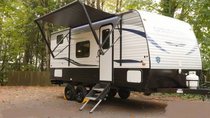 Spacious travel trailer RV rental with extended awning & steps, ready for your outdoor adventures.. Keystone RV Springdale 2022