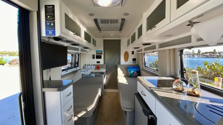 Modern RV rental interior: twin beds, compact kitchen, and scenic waterfront views for travel.. Coachmen Nova20 Li3.  Lithium / generator free silent power 2022