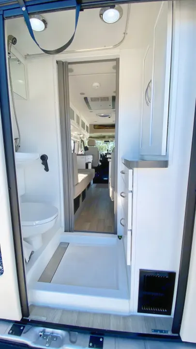Compact RV rental interior: featuring a functional bathroom with shower, toilet, and an efficient living space.. Coachmen Nova20 Li3.  Lithium / generator free silent power 2022