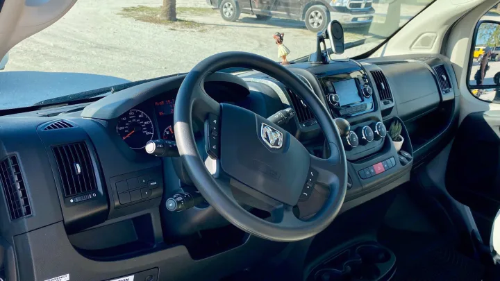 Inside a Ram ProMaster RV rental: detailed dashboard, steering wheel, and infotainment system, perfect for road trips.. Coachmen Nova20 Li3.  Lithium / generator free silent power 2022