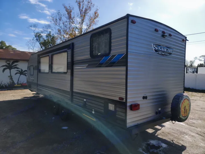 This gray travel trailer RV rental is ready for your next adventure! See its sleek design, multiple windows, and fun spare tire cover.. Forest River Salem Cruise Lite 2020