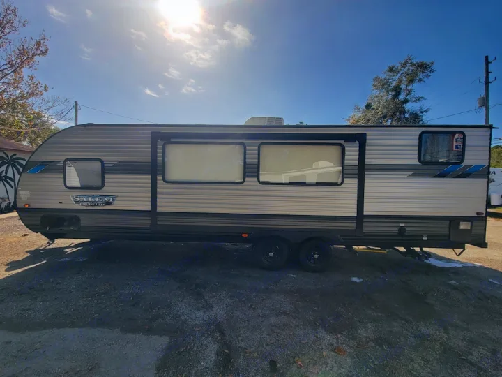 Gray Salem Cruise Lite travel trailer for RV rental, parked outdoors on a sunny day, ready for adventures.. Forest River Salem Cruise Lite 2020