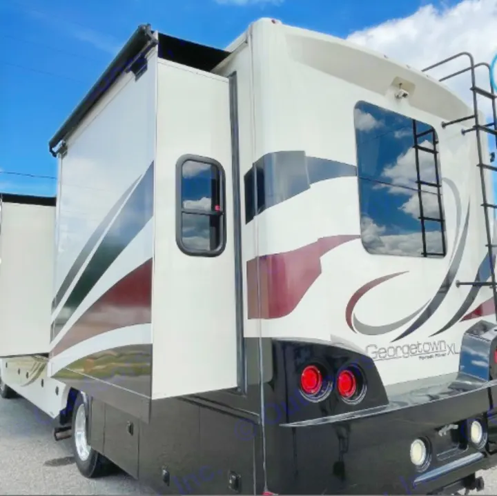 Side view of a cream and black Georgetown XL RV rental with an extended slide-out and rear ladder. Perfect for travel.. Georgetown XL 2015