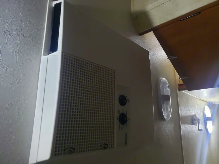 Dometic RV air conditioner and cabin lights are visible in this RV rental interior, offering climate control and lighting.. Coachmen Apex 2012