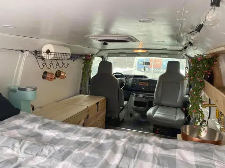 Cozy custom vanlife rv rental: bed, mini kitchen, & driver's cab view for your next adventure.. Ford Econoline 2012