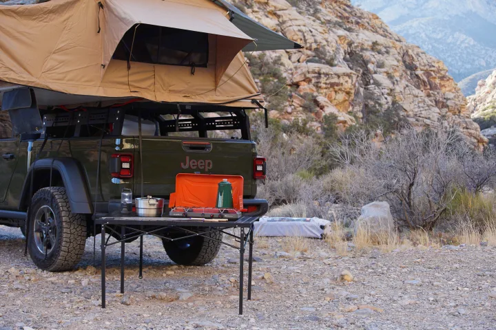 Jeep Gladiator with rooftop tent, perfect for an rv rental adventure. Overlanding setup, camp kitchen in scenic desert.. Fiat Jeep Gladiator 2023