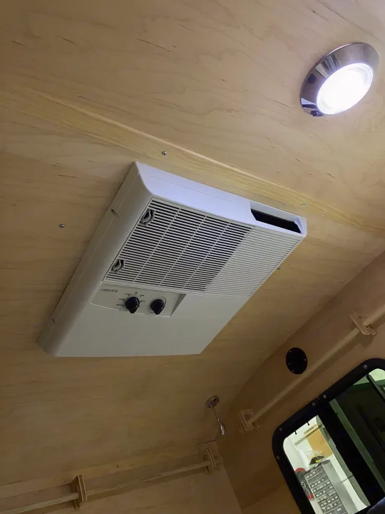 Bright RV rental interior: wooden walls, built-in light, window, and Advent AC unit for comfort.. TC Tear Drop TC Original 2022