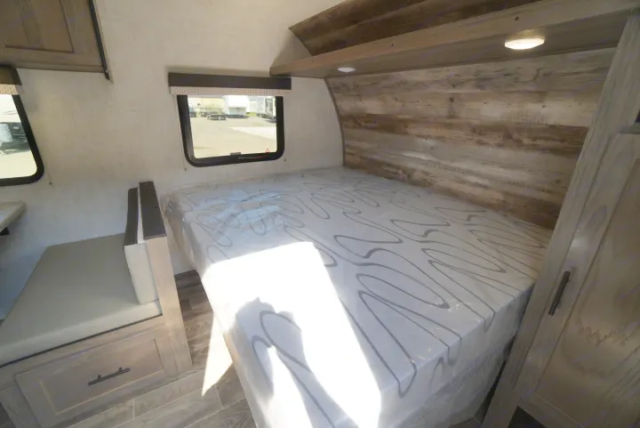 Bright RV rental interior: a new bed, dinette, and wood finishes create a welcoming travel space.. Gulf Stream Trailmaster 2022