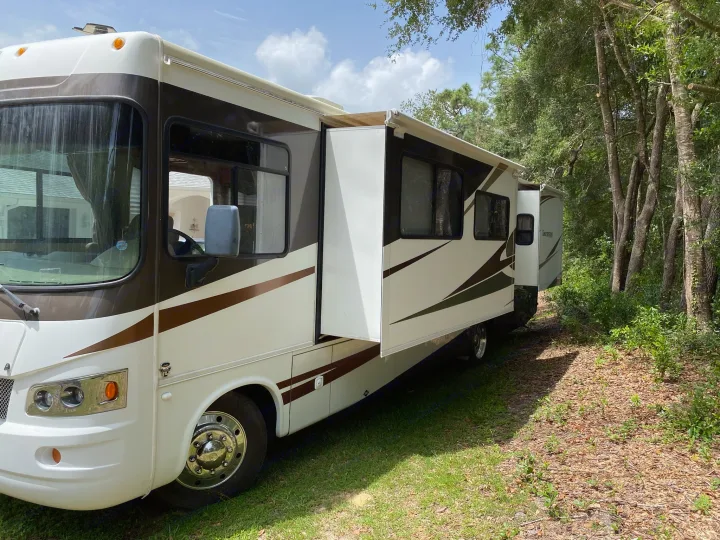 Spacious white and brown RV rental parked outdoors, slide-out extended. Ready for your camping trip.. Georgetown Georgetown Motorhome 2010