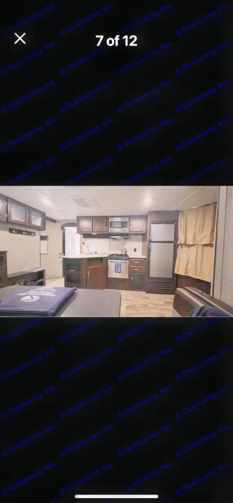 Spacious RV rental interior featuring a modern kitchen with stove, microwave, fridge, and a comfortable living area.. Keystone RV Springdale 2019