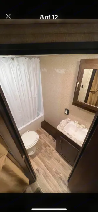 This RV rental features a well-equipped bathroom with a shower, toilet, and mirrored vanity.. Keystone RV Springdale 2019