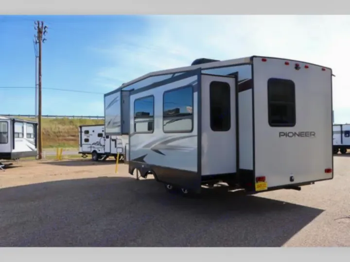 A large white Pioneer travel trailer RV with extended slide-outs, ready for your next rv rental adventure.. Heartland RVs Pioneer 2020