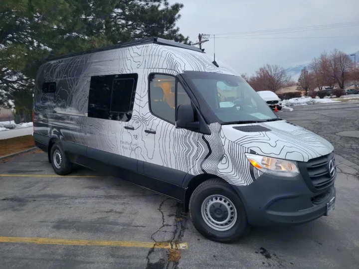 This Mercedes-Benz Sprinter rv rental features a unique topographic map wrap, ideal for travel & outdoor adventures.. Mercedes-Benz Sprinter 2022