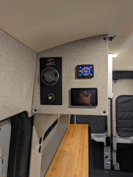 RV rental interior: A detailed shot of the control panel featuring a Cruise N Comfort unit, Elwell thermostat, and Victron Energy monitor.. Grit Overland GO A/T 2022