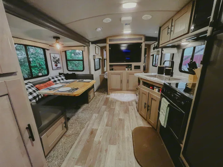 Spacious RV rental interior featuring a bright dining area, full kitchen, and comfortable living space for your adventures.. Heartland RVs Sundance Ultra Lite 2021