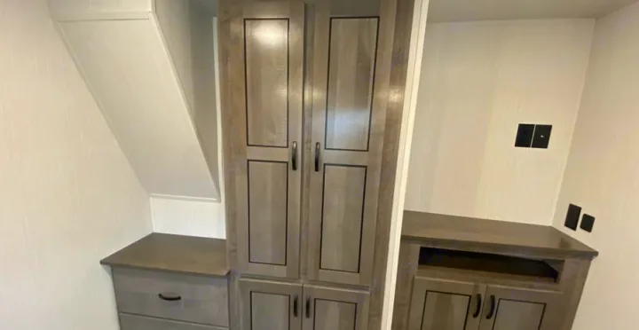 RV rental interior showing light grey cabinetry: a tall wardrobe, a dresser, and a media cabinet for efficient storage.. Forest River Other 2022