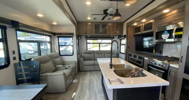 Spacious, modern RV rental interior with living area, kitchen island, stove, and comfortable seating.. Forest River Other 2022