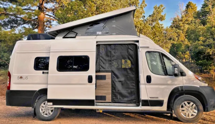 This white Winnebago Solis camper van RV rental, with its pop-top roof open, is ready for your next adventure in nature.. Winnebago Solis 2021