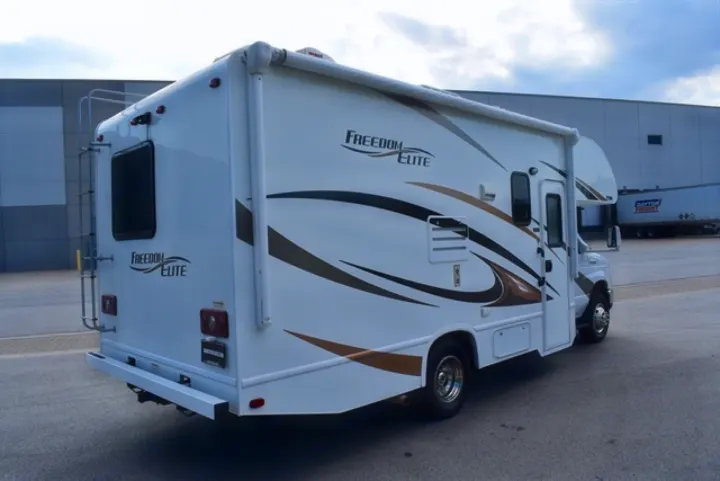 White Freedom Elite RV rental with bold graphics, rear ladder, and awning. Perfect motorhome for your next travel adventure.. Thor Freedom Elite 2016