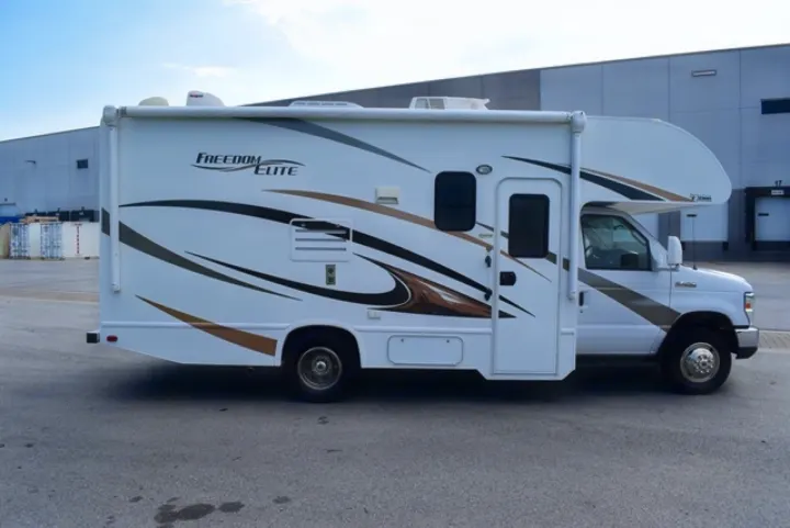 A clean white rv rental motorhome with distinctive brown and black decals, ready for your next road trip adventure.. Thor Freedom Elite 2016
