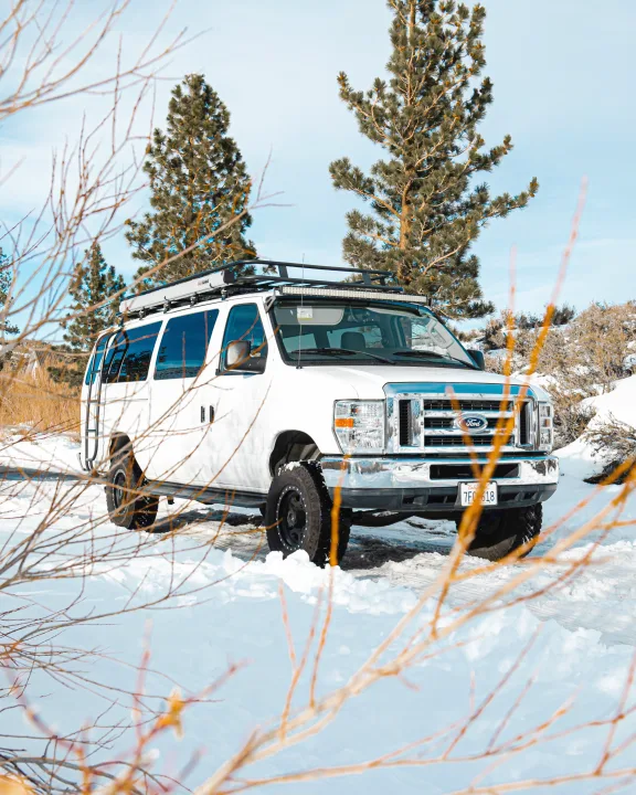 This white Ford van, equipped for snow, could be your next RV rental adventure.. Ford Ford E350 2014