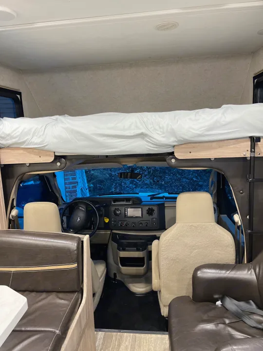 This RV rental's interior features an overhead bunk bed, driver's cockpit, and comfy dinette.. Forest River Sunseeker 2019