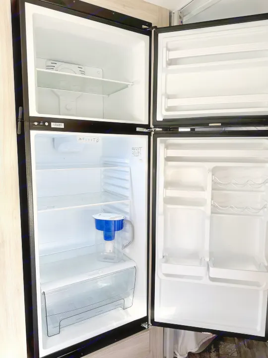 Inside a clean, empty RV rental refrigerator and freezer, complete with a water filter pitcher. Ready for your adventure!. Forest River Sunseeker LE 2021