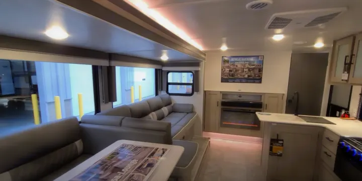 Spacious RV rental interior featuring a comfy lounge, modern kitchen, and electric fireplace for comfortable journeys.. Forest River Other 2023