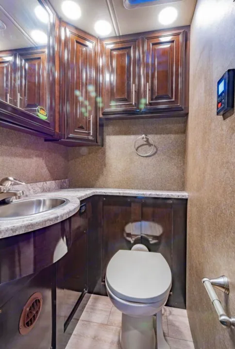 Clean, modern RV rental bathroom with vanity, sink, toilet, and ample cabinet space for your travels.. Thor Motor Coach Challenger 2019