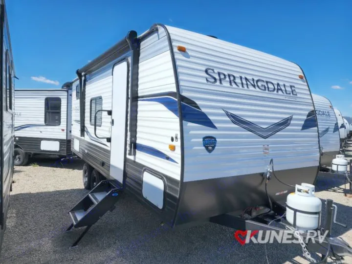 New Springdale travel trailer for RV rental, with steps out and a propane tank visible.. Keystone Springdale 2022
