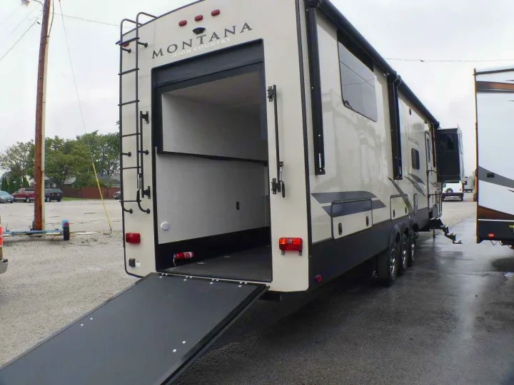 Rear view of a Montana High Country toy hauler RV with an open ramp, ideal for rv rental adventures.. Keystone RV Montana High Country Toy Hauler 2019