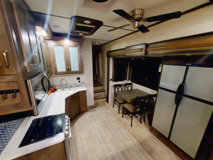 Explore this modern RV rental's spacious interior: full kitchen, dining, and large fridge. Your comfortable mobile home awaits!. Keystone RV Montana High Country Toy Hauler 2019