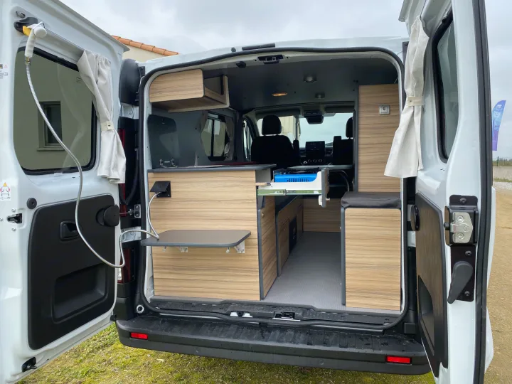 Explore your next adventure with our RV rental campervan, featuring a compact kitchen, storage, and cozy living space.. Renault TRAFIC 2023