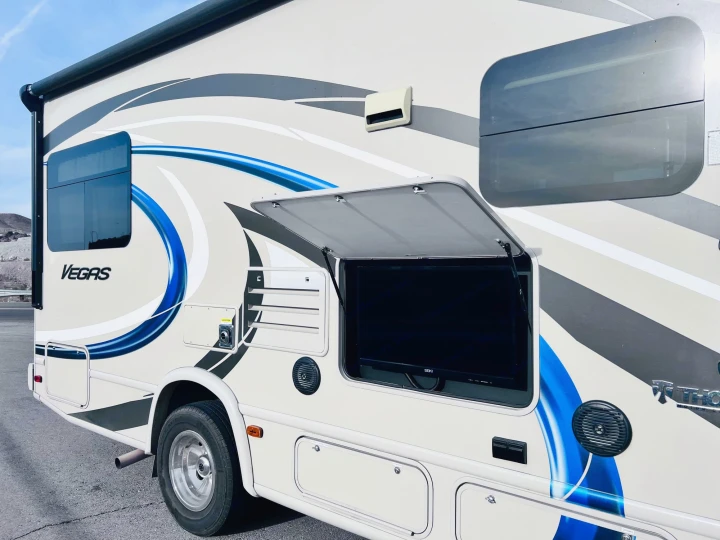 This white 'Vegas' rv rental boasts a convenient outdoor TV in an open side compartment. Ready for your next adventure!. Thor Vegas 2017