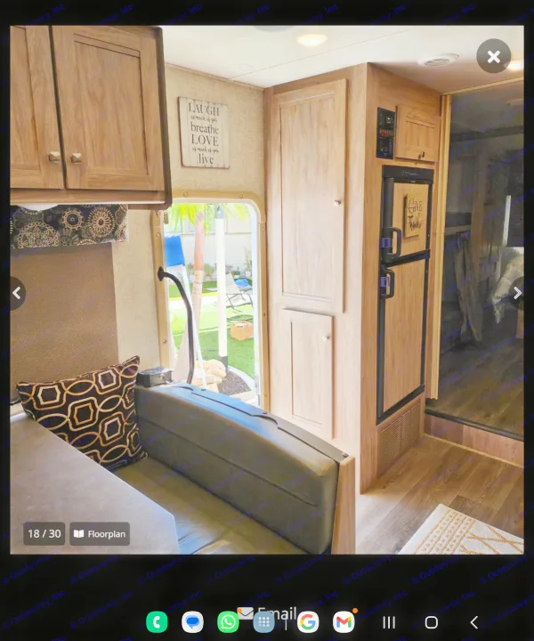 This RV rental showcases a comfortable interior with a dinette, wood cabinets, refrigerator, and a window looking out to a green yard.. Forester Forester Motorhome 2017