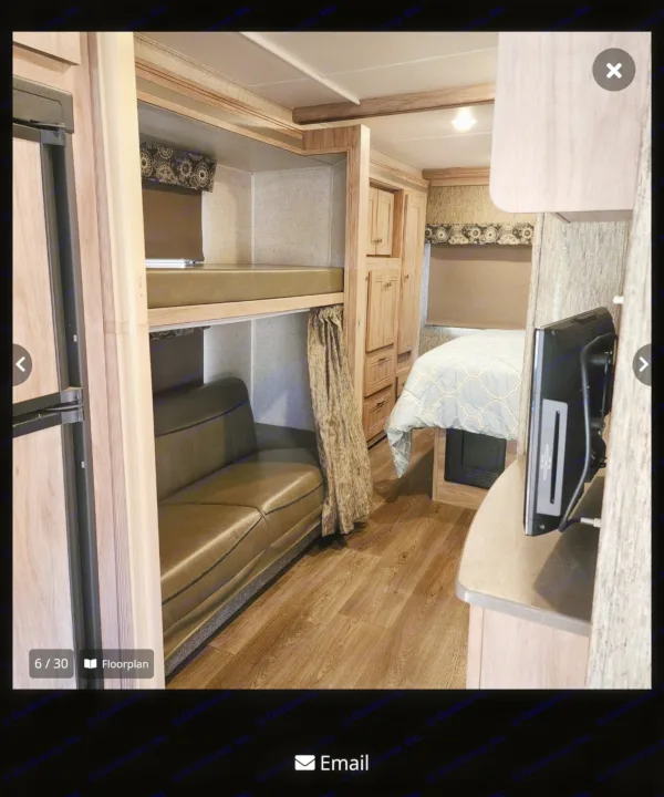 RV rental interior: bunk beds, sofa, bed, fridge, and TV. A cozy space for family travel adventures.. Forester Forester Motorhome 2017