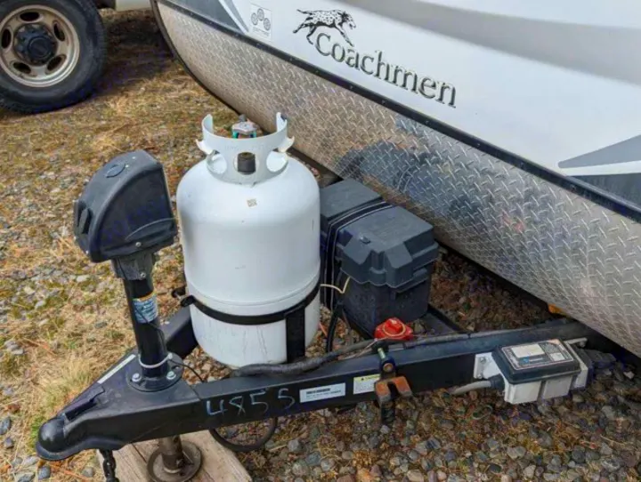 An RV rental's front hitch, propane tank, and battery box. Essential components for mobile camping and travel.. Coachmen Apex Nano 2019