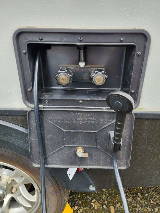 RV rental's outdoor shower with detailed winterization instructions for seasonal preparation.. Keystone RV Passport Grand Touring 2018
