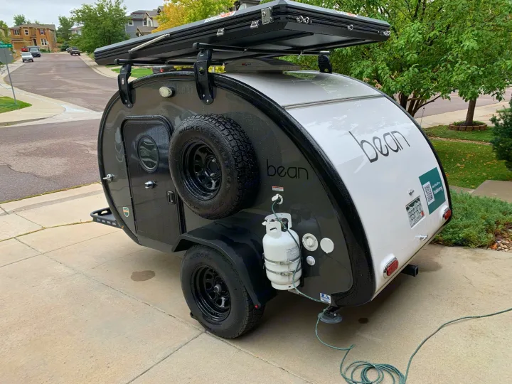 Small black and white teardrop rv rental with rooftop tent. Ready for your next camping travel adventure.. Bean Trailer Mean 2020