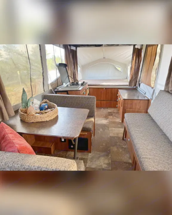 Inside this RV rental: a welcoming dinette, compact kitchenette, and cozy bed area await your next adventure.. Flagstaff/ForestRiver M.A.C.SeriesM-228 2016
