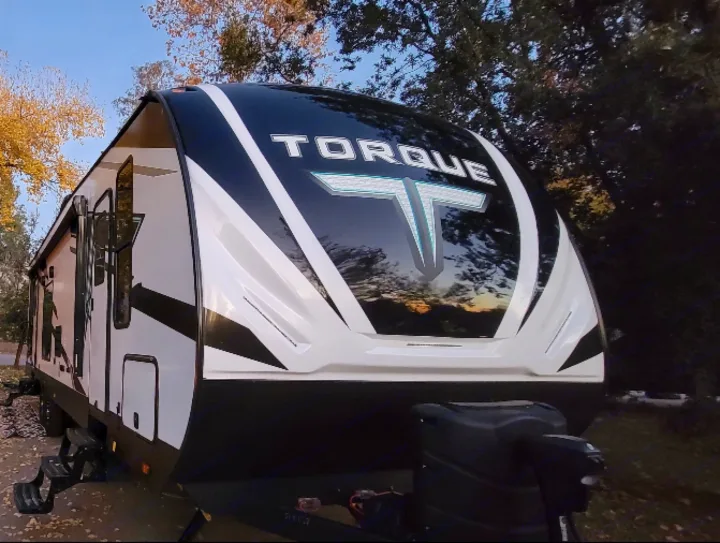 Torque RV rental: Front view of a white & black travel trailer parked outdoors, ready for adventure.. Heartland Torque 2022