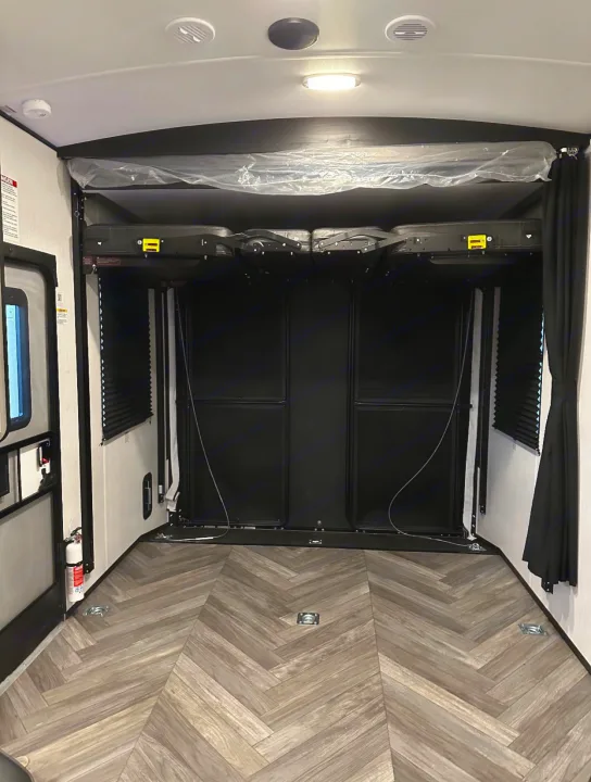 This RV rental's versatile toy hauler garage includes an overhead bed system, fold-up seating, and durable floor with tie-downs.. Heartland Torque 2022