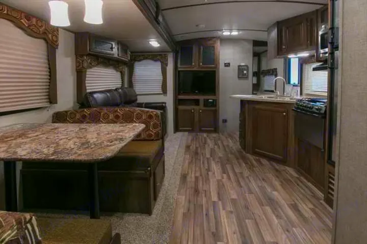Spacious RV rental interior with dinette, sofa, and kitchen, offering comfortable living on the go.. Keystone Cougar Xlite 2020